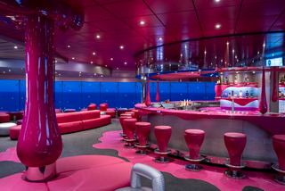 Contemporary bar with vibrant seating and sea views for entertainment onboard | MSC Cruises
