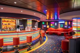 Manhattan Bar features vibrant lighting and inviting seating for relaxation | MSC Cruises