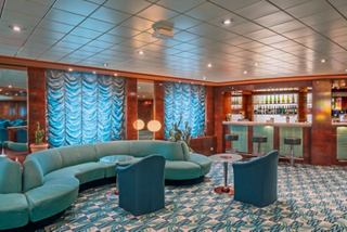 Inviting bar lounge with comfortable seating and warm ambiance for relaxation and gathering | MSC Cruises