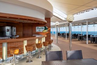 Modern open-air bar area on a cruise ship with sea views and inviting seating spaces | MSC Cruises