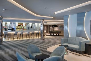 Panorama Lounge featuring a bar, comfortable seating and tables for entertainment and relaxation | MSC Cruises