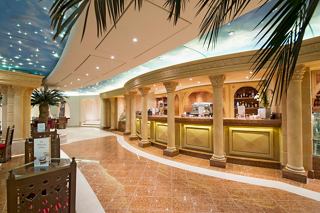 Phoenician Plaza on MSC Preziosa features a bar counter, columns and palm trees | MSC Cruises