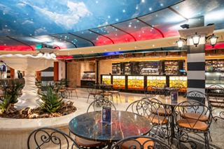 Piazza San Giorgio features a fountain, bar counter, tables and chairs on MSC Fantasia | MSC Cruises