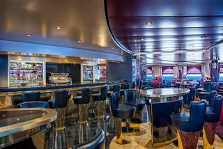 Pigalle Lounge features comfortable seating, a bar counter and sea views aboard MSC Poesia | MSC Cruises