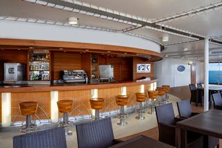 Pirana Bar on a cruise ship featuring seating areas and a scenic sea view | MSC Cruises