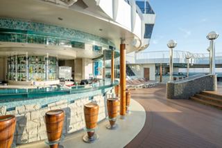 Outdoor bar with stools and sea views on a ship from the fleet | MSC Cruises