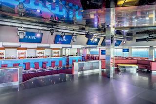 Q32 Disco bar with vibrant seating and spacious dance floor aboard MSC Musica | MSC Cruises