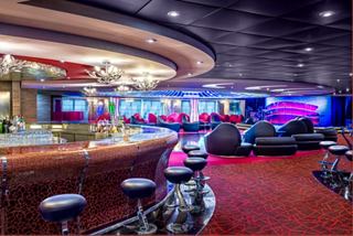 Bar and lounge with cozy seating and stage aboard the MSC Splendida | MSC Cruises
