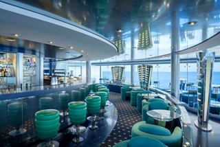 Modern bar with comfortable seating and expansive windows overlooking the sea | MSC Cruises