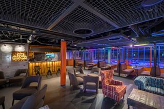The Box Bar on MSC World Europa features modern seating and vibrant lounge ambiance | MSC Cruises