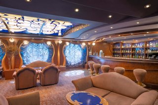 The Cigar Lounge on MSC Divina features armchairs, tables and a welcoming bar area | MSC Cruises