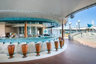 Bar with tall stools and pool view on MSC Fantasia ship | MSC Cruises