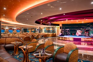 The Savannah Bar on MSC Orchestra includes inviting seating, a stage and a piano | MSC Cruises