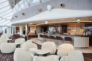 Top Sail Lounge in MSC Yacht Club features comfortable seating and a stylish bar counter | MSC Cruises