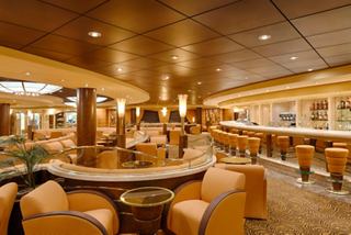 Inviting lounge with bar, soft seating and warm lighting on MSC Magnifica | MSC Cruises
