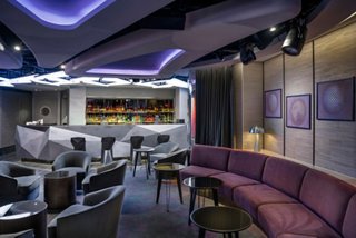 Contemporary bar and lounge featuring comfortable seating and ambient lighting | MSC Cruises