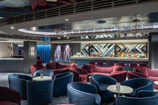 Contemporary lounge with inviting seating and a bar counter on MSC Seascape | MSC Cruises