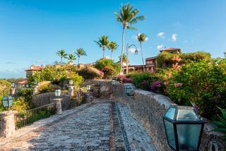 Walkway with palm trees and flowers in Altos de Chavon village, Dominican Republic | MSC Cruises