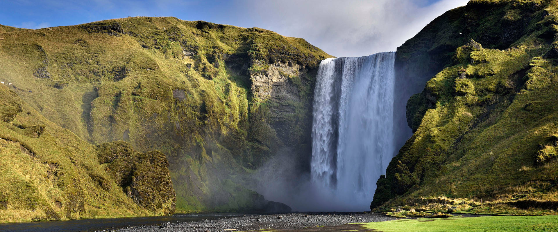 Skogafoss waterfall surrounded by green hills in Iceland inspires adventurous journeys | MSC Cruises