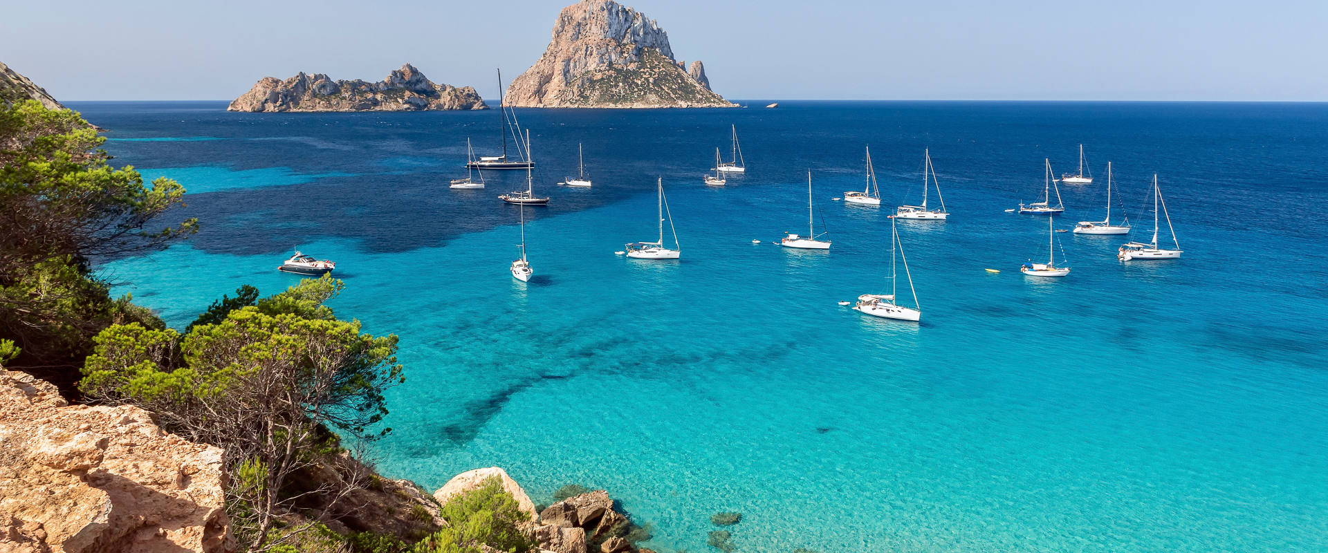 Mediterranean coastline with turquoise sea and boats near rocky islands | MSC Cruises