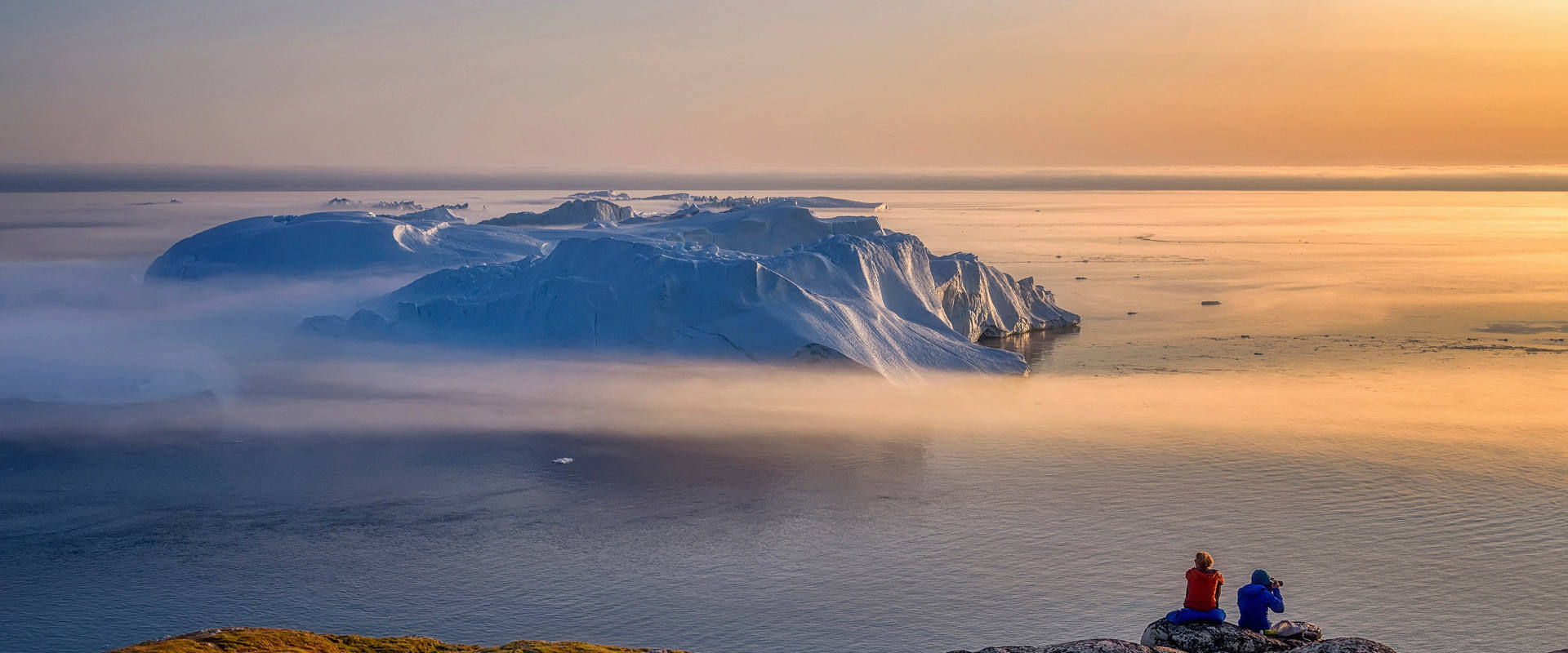 Northern Europe coastline at sunset with sea and iceberg in the distance | MSC Cruises