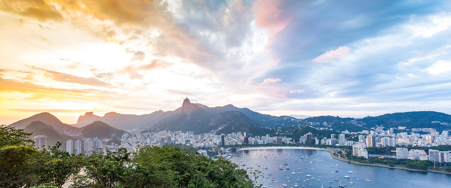 Panoramic view of Rio de Janeiro with sea, city skyline, mountains and sunset colors | MSC Cruises