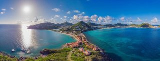 Panoramic view of an island with blue sea, harbor and green hills | MSC Cruises
