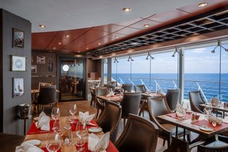 Speciality restaurant with sea views and inviting tables aboard MSC Poesia | MSC Cruises
