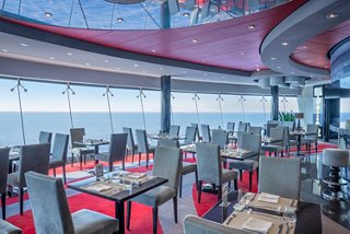 Contemporary restaurant featuring sea views, stylish tables and comfortable seating | MSC Cruises