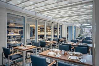 Bright restaurant featuring modern tables and chairs on MSC World Europa | MSC Cruises