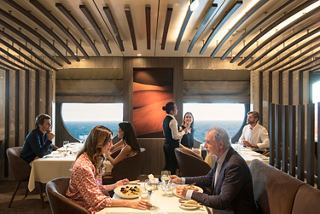 Guests enjoy attentive dining service at a restaurant on MSC World Europa | MSC Cruises