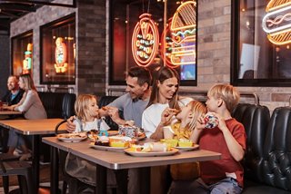 A family enjoys delicious food together in a welcoming restaurant setting | MSC Cruises