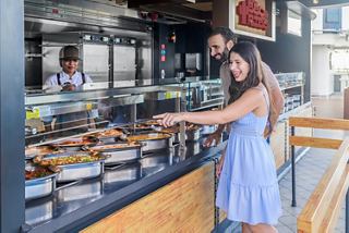 A couple selects from a tempting buffet aboard a cruise ship for a memorable dining experience | MSC Cruises