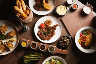 A variety of gourmet dishes and sauces served on a restaurant table aboard a cruise ship | MSC Cruises
