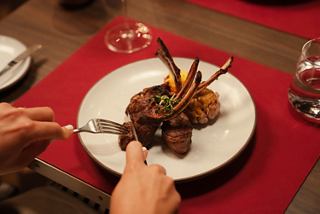 A gourmet lamb dish served on a beautifully arranged dining table | MSC Cruises