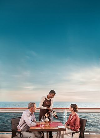 Guests enjoy outdoor dining with ocean views on board a cruise ship | MSC Cruises