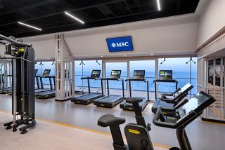 Contemporary gym with fitness machines and sea views for an energizing onboard experience | MSC Cruises