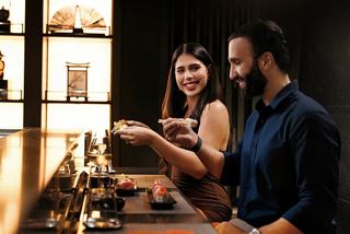 Two people enjoy a lively moment together in the inviting ambiance of MSC Cruises | MSC Cruises
