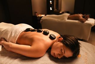 Relax with a spa massage using warm stones for harmony and renewal | MSC Cruises