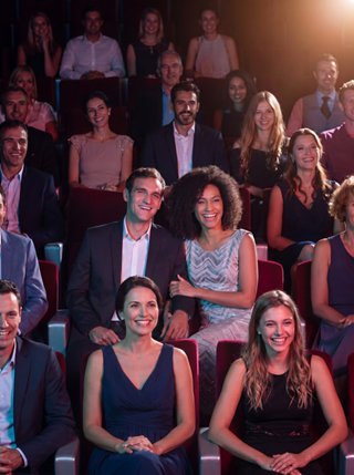 A crowd of guests is enjoying a live performance in the theater aboard the cruise ship | MSC Cruises