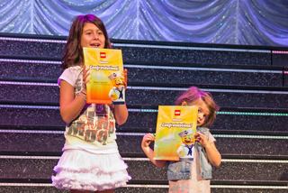 Children hold diplomas on stage during fun family entertainment activities | MSC Cruises
