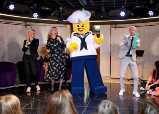 Family entertainment on stage with a LEGO mascot and guests enjoying a cruise experience | MSC Cruises