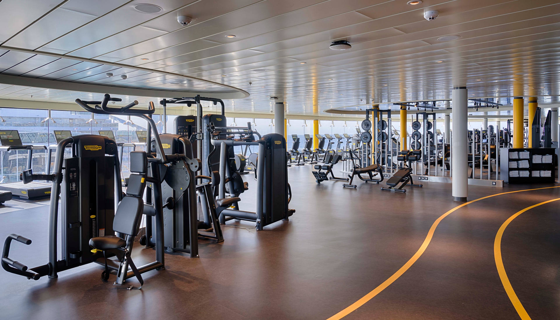 Modern gym on a ship featuring Technogym equipment and spacious windows | MSC Cruises