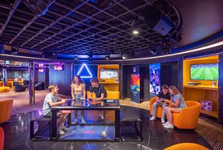 Teens enjoy games and activities in a vibrant and modern MSC Teen Club lounge | MSC Cruises