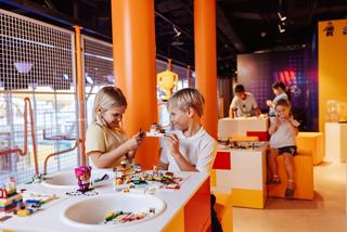 Children enjoy building with LEGO bricks in a vibrant family zone onboard | MSC Cruises