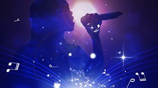 Performer on stage holding a microphone surrounded by vibrant lighting effects | MSC Cruises