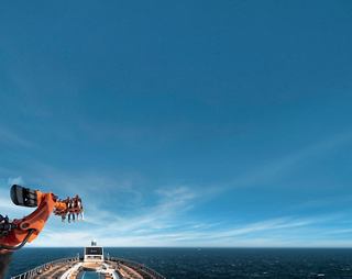 Robotron ride on MSC Seascape with family enjoying under a vibrant blue sky | MSC Cruises