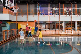 Families and crew enjoy basketball together in the vibrant sportplex on the cruise ship | MSC Cruises