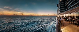A stunning view from the ship’s deck overlooking the sea and a sunset on the horizon | MSC Cruises