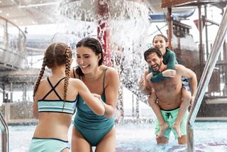 Family enjoys playful moments together at the aquapark pool on board a cruise ship | MSC Cruises